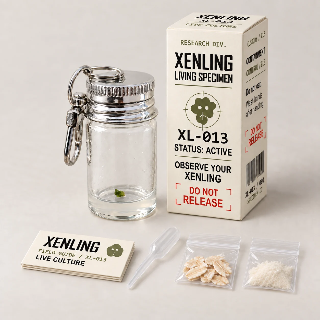 Xenling kit contents: living culture in a glass vial, specimen box, folded care guide, pipette, oat food, and spare substrate powder